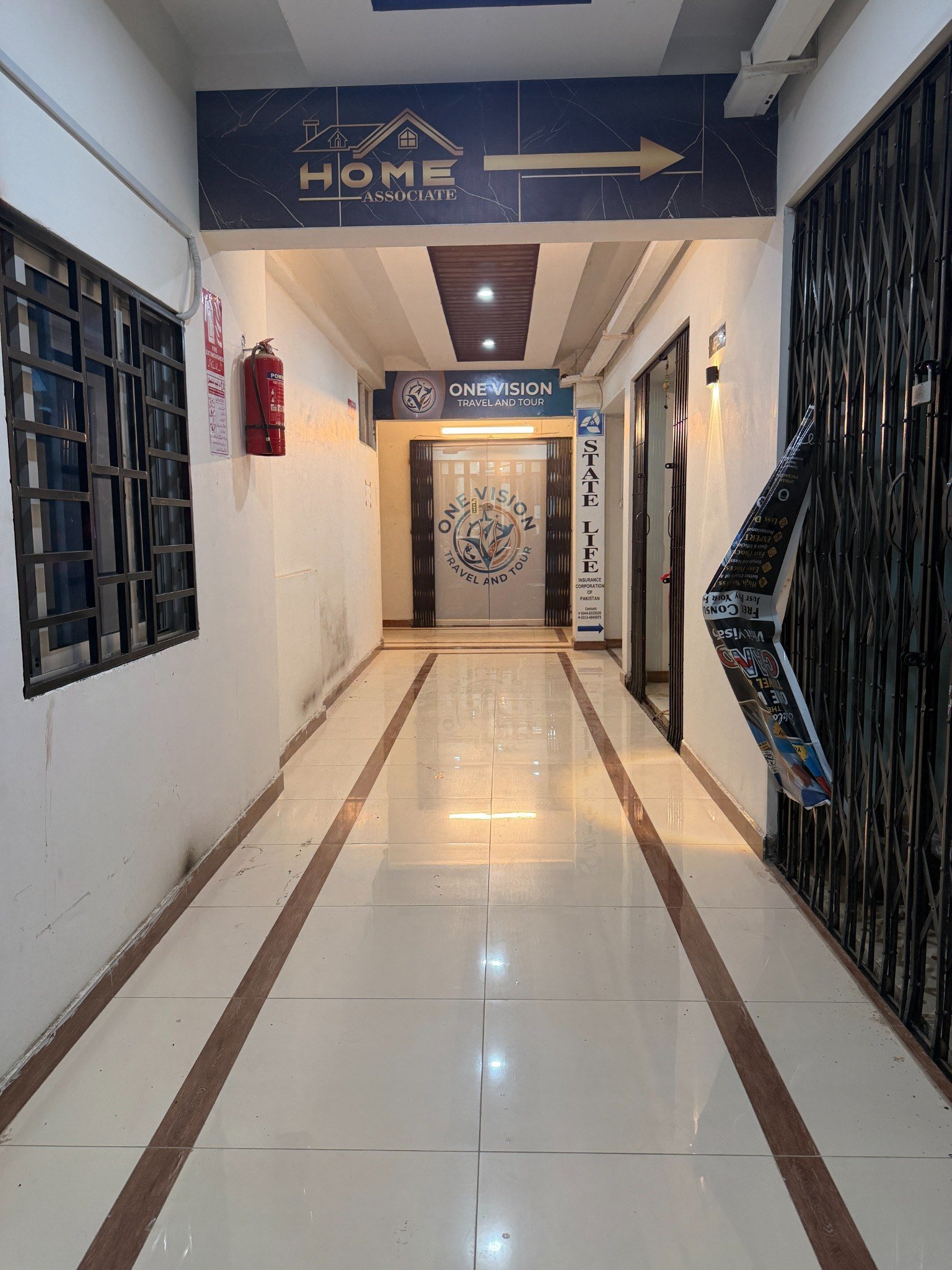 Corridor leading to One Vision Travel and Tour office at Comfort Plaza